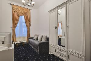 a living room with a couch and a large cabinet at Hotel Carol - Vatra Dornei in Vatra Dornei +67 photos