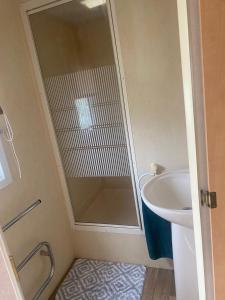 a bathroom with a shower and a sink at KC Caravans in Ingoldmells +6 photos