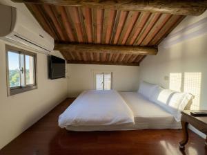 a bedroom with a large bed with a wooden ceiling at Zhong Lan Homestay in Chung-lan