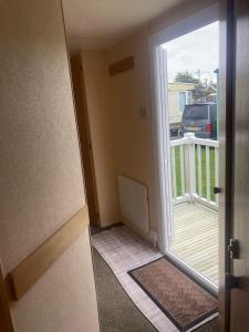 an open door to a balcony with a view at KC Caravans in Ingoldmells