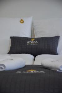 a black bed with two pillows on top of it at Stopa Art Residence in Šempeter pri Gorici