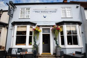 a white building with flowers in front of it at Abbey Fields By Chef & Brewer Collection in Kenilworth +19 photos