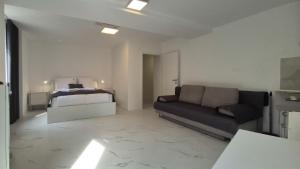 a living room with a couch and a bed at Stopa Art Residence in Šempeter pri Gorici