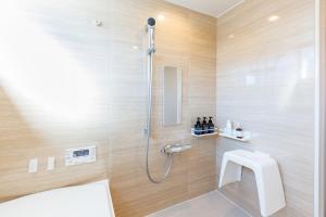 a bathroom with a shower with a toilet and a sink at Villa Ferme Yatsugatake in Hokuto