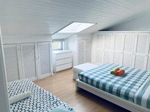 a bedroom with two twin beds and white cabinets at Gama House Shared Appartment in Lisbon