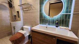 a bathroom with a sink and a mirror and a toilet at Old City Hall, Contactless Check In in Bangkok +11 photos