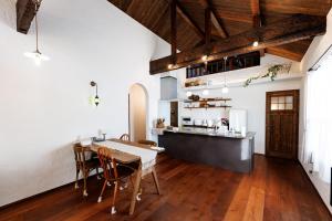 a kitchen and dining room with a table and chairs at Villa Ferme Yatsugatake in Hokuto +8 photos