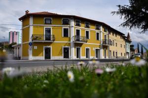 a yellow building on the side of a street at Stopa Art Residence in Šempeter pri Gorici