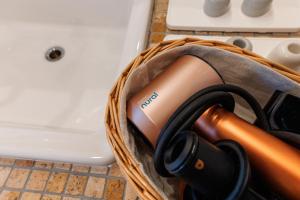 a bag with a hair dryer in it next to a sink at Villa Ferme Yatsugatake in Hokuto
