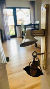 a bell hanging on the door of a house at Comfort Doppelzimmer mit Balkon und Blick ins Grüne in Mespelbrunn +7 photos
