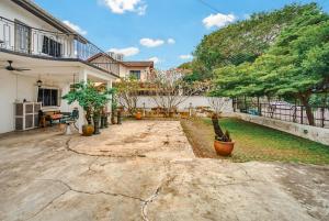 a courtyard of a house with trees in it at Ruum1 Sugars Houz in Johor Bahru