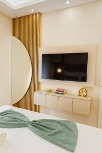 a bedroom with a flat screen tv on a wall at Panorama GOLD Vrnjačka Banja in Vrnjačka Banja