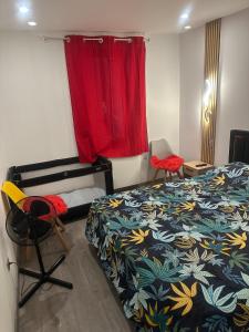a bedroom with a bed and a red curtain at glamour chic maison de 70 m2 in Montluçon