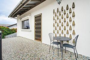 a patio with a table and chairs in front of a building at Ruum1 Sugars Houz in Johor Bahru