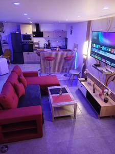 a living room with a couch and a table at glamour chic maison de 70 m2 in Montluçon