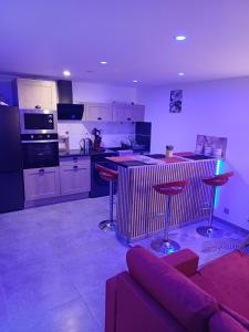 a living room with a couch and a kitchen at glamour chic maison de 70 m2 in Montluçon +28 photos