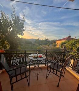 a table and chairs on a balcony with a view at Fenareti Apartments in Skala Eresou