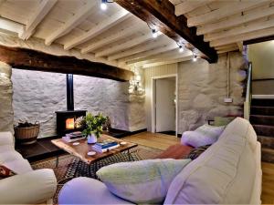 a living room with a couch and a fireplace at 3 Bed in Tyn Y Groes oc-80476 in Caerhûn