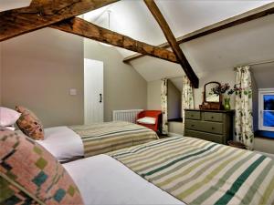 a bedroom with two beds and a dresser in it at 3 Bed in Tyn Y Groes oc-80476 in Caerhûn