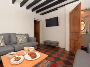 a living room with a couch and a table at 3 Bed in Conwy oc-85844 in Llanbedr-y-cennin