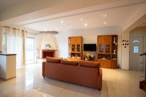 a living room with a couch and a fireplace at Natural Quiet Accommodation 3 - Faliraki in Kalithies