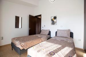 a bedroom with two beds in a room at Natural Quiet Accommodation 3 - Faliraki in Kalithies