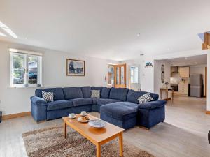 a living room with a blue couch and a table at 2 Bed in Arthog oc-43105 in Arthog