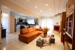 a living room with a couch and a table at Natural Quiet Accommodation 3 - Faliraki in Kalithies