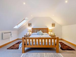 a bedroom with a wooden bed in a attic at 2 Bed in Arthog oc-43105 in Arthog