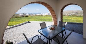 a patio with a table and chairs on a balcony at Etherio Apartments Naxos in Galanádhon