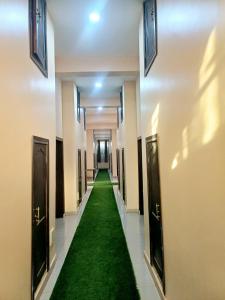 a hallway with a green carpet in a building at SARAB HOTEL Wau in Juba
