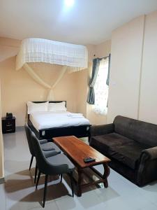 a living room with a bed and a couch at SARAB HOTEL Wau in Juba
