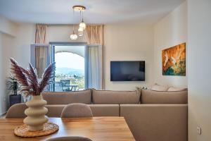 a living room with a couch and a table at Etherio Apartments Naxos in Galanádhon