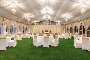 a large tent with white tables and chairs on grass at Hotel Himalaya Kathmandu - Your Business & Leisure Retreat in Kathmandu +71 photos