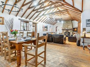 a living room with a table and a fireplace at 3 Bed in Swansea oc-93942 in Ilston