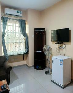 a living room with a refrigerator and a television at SARAB HOTEL Wau in Juba