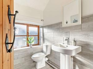 a bathroom with a white toilet and a sink at 3 Bed in Swansea oc-93942 in Ilston +19 photos