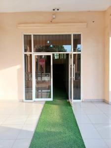an open door of a building with a green carpet at SARAB HOTEL Wau in Juba