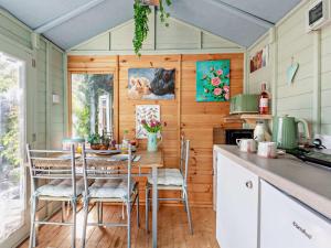 a kitchen with a table and chairs in a room at 1 Bed in Denbigh oc-91890 in Llanrhaiadr
