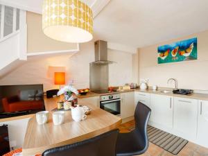 a kitchen with a wooden table and a dining room at 1 Bed in Corwen oc-52509 in Corwen