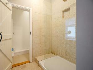 a bathroom with a tub and a shower stall at 1 Bed in Corwen oc-52509 in Corwen +16 photos