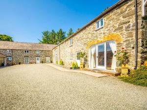 a stone house with a driveway in front of it at 1 Bed in Corwen oc-52509 in Corwen