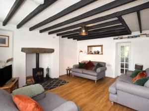 a living room with two couches and a fireplace at 3 Bed in Pwllheli oc-55571 in Nefyn