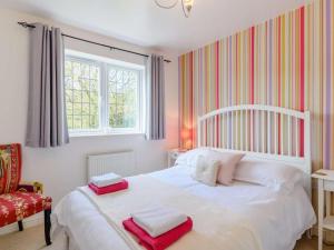a bedroom with a white bed with two towels on it at 3 Bed in Stepaside oc-fb047 in Stepaside