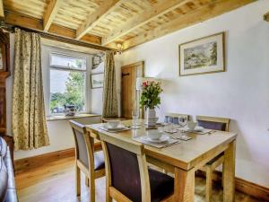 a dining room with a wooden table and chairs at 2 Bed in Swansea oc-62019 in Reynoldston