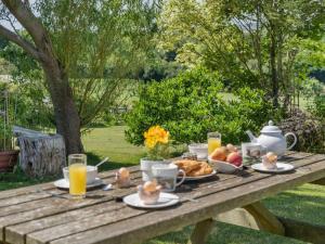 a picnic table with breakfast food and orange juice at 2 Bed in Swansea oc-62019 in Reynoldston