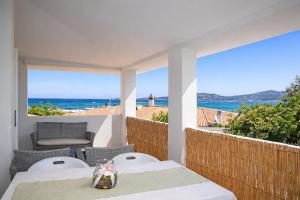 a table and chairs on a balcony with a view of the ocean at La Conia Sea View Retreat in Cannigione