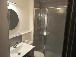 a bathroom with a shower and a sink and a toilet at Hôtel Du Mans in Angers