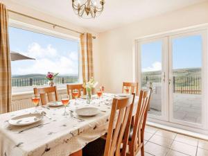 a dining room with a table and chairs and a large window at 4 Bed in Denbigh oc-62368 in Denbigh