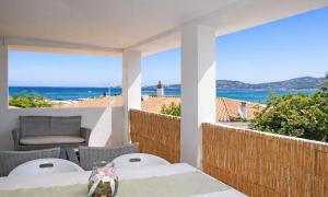 a table and chairs on a balcony with a view of the ocean at La Conia Sea View Retreat in Cannigione